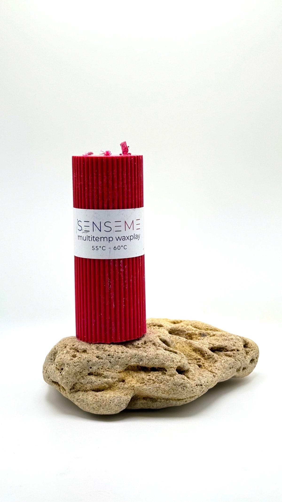65°C Red SenseMe wax play candle on a stone — palo santo scent